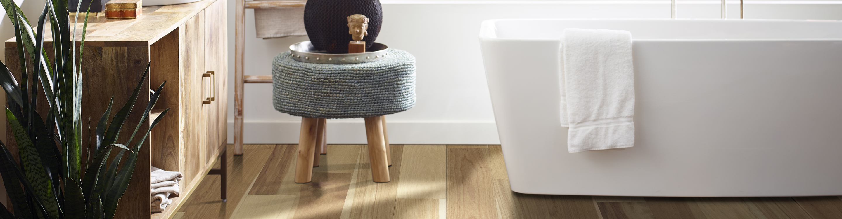 light waterproof wood flooring in kitchen with white soaker tub