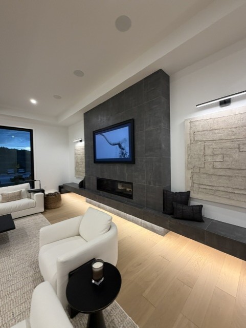 living room with custom fireplace and custom lighting