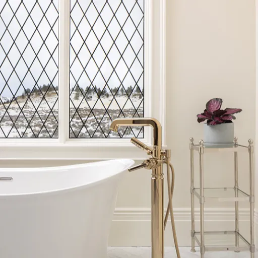 White bathtub with brass faucet 