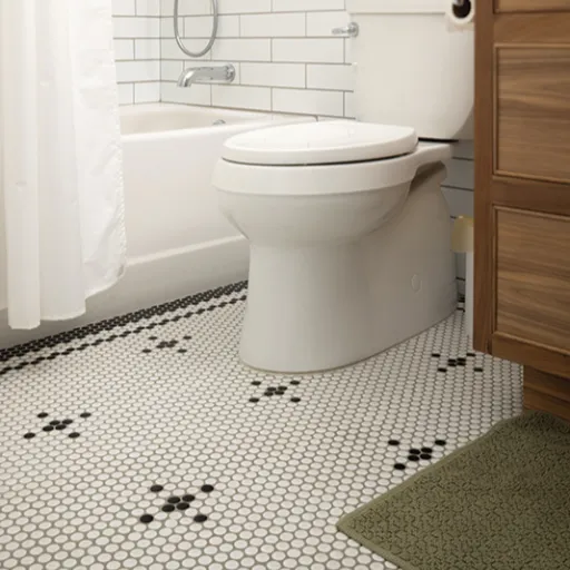 Commode with subway tile wall and mosaic tile floor.